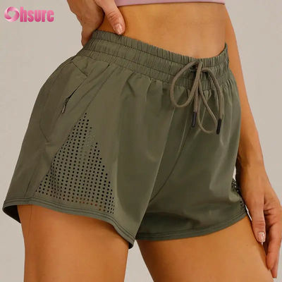 Shorts de sport d'entraînement pour femmes en gros, respirants, avec découpe laser, shorts de jogging avec poche latérale zippée d'échauffement, motif uni